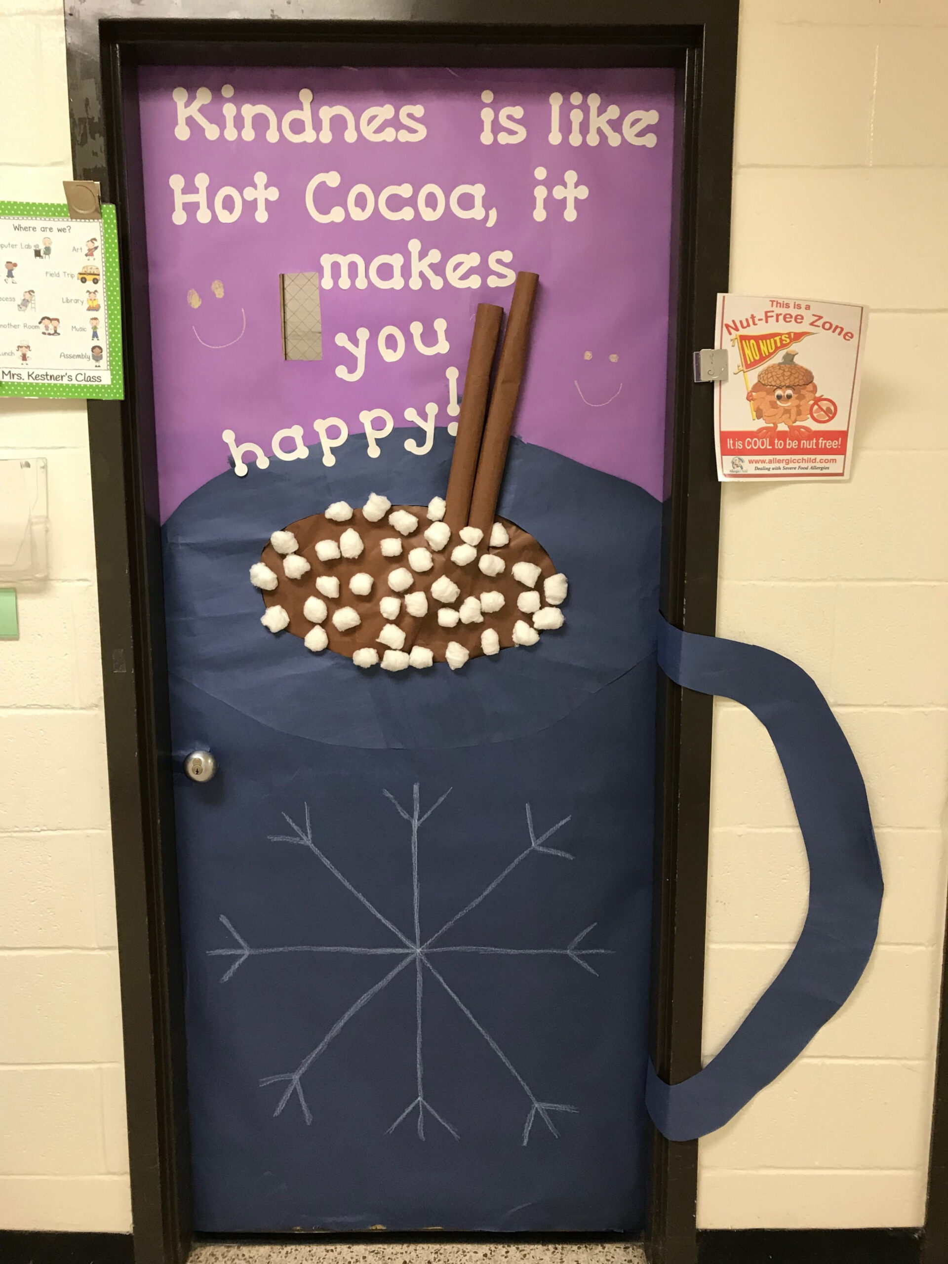 Classroom door decorated for winter with huge mug of hot chocola