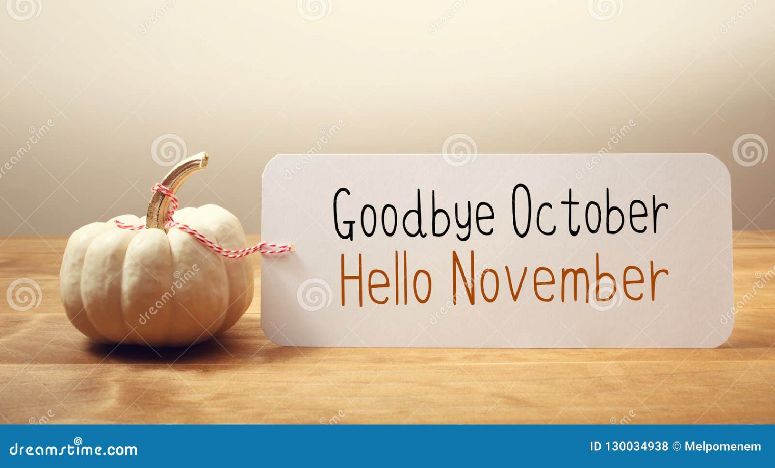 Goodbye October Hello November Message with a Small Pumpkin Stock