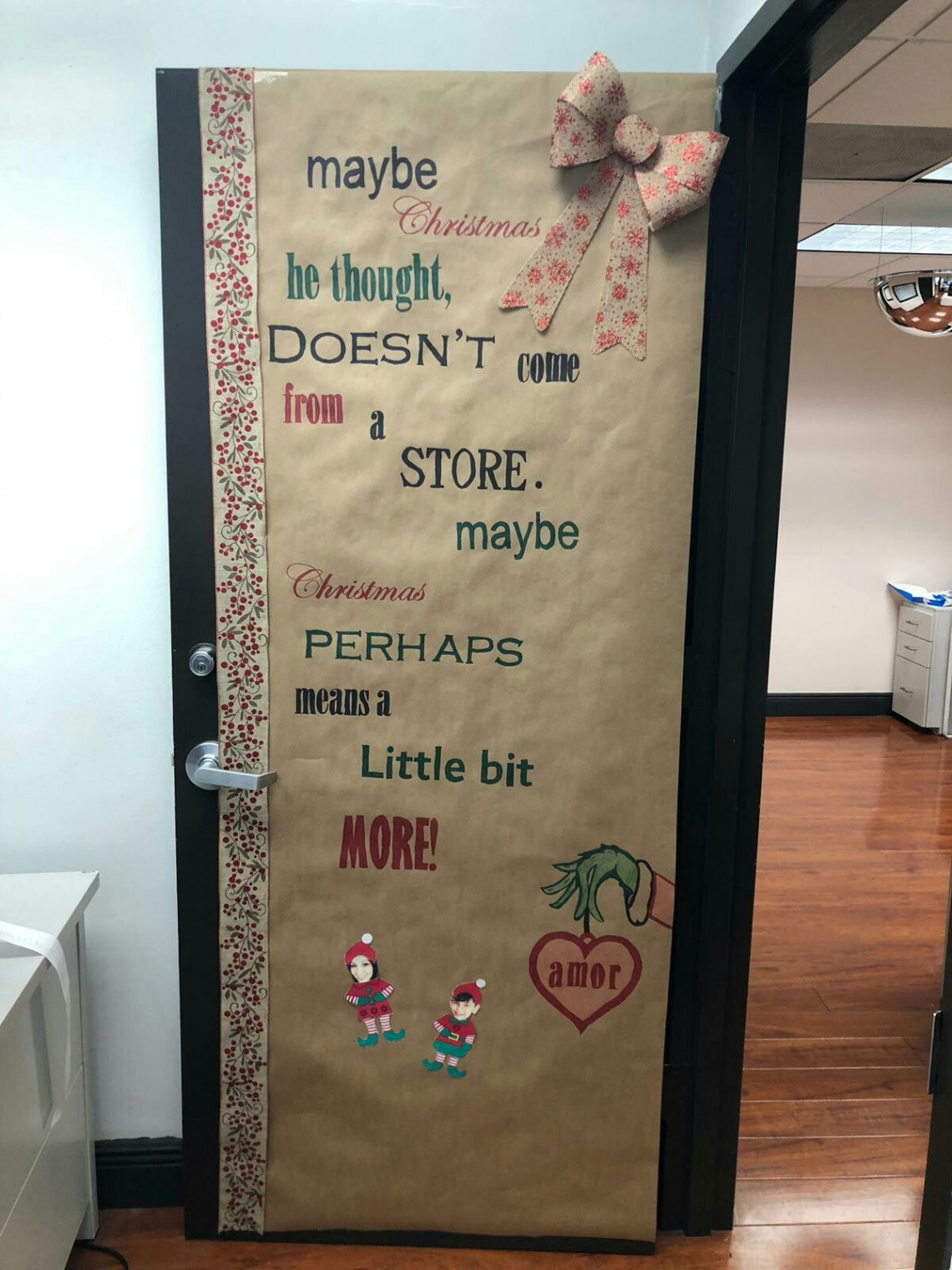 Office door decorated with a Grinch quote for Christmas