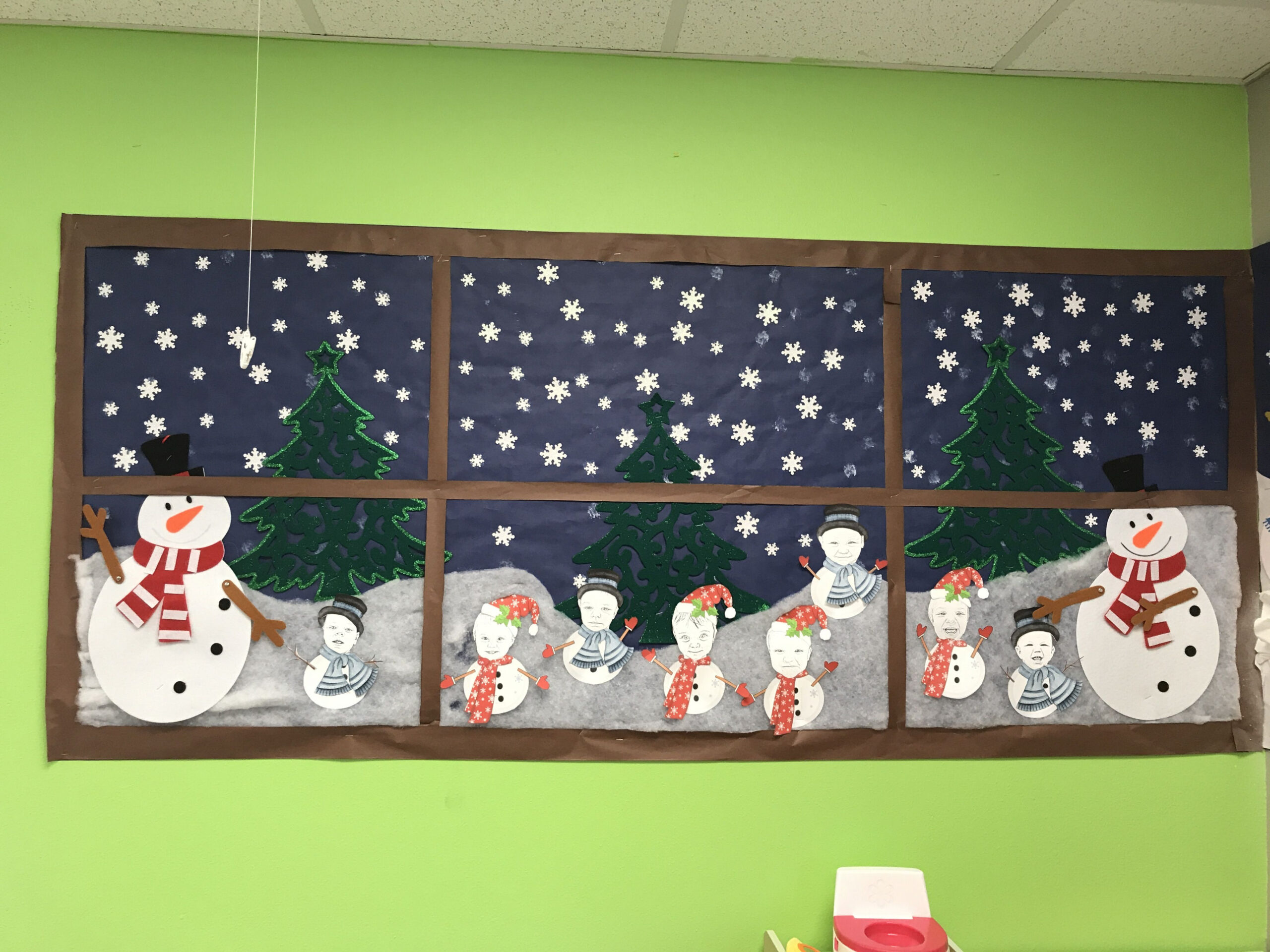 Window of winter and class of toddlers as little snowmen